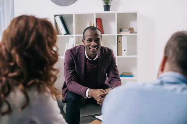 Three people attend a mental health team meeting