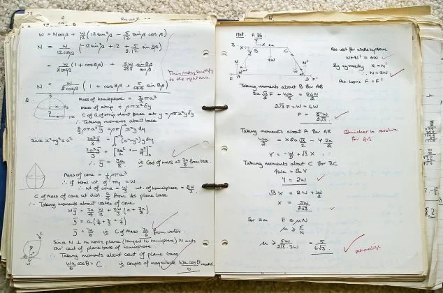 Open notebook with written math practice inside