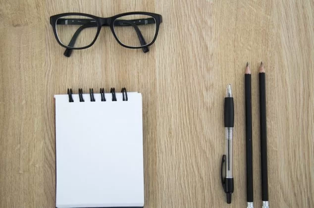 Nerdy glasses with writing utensils and notebook