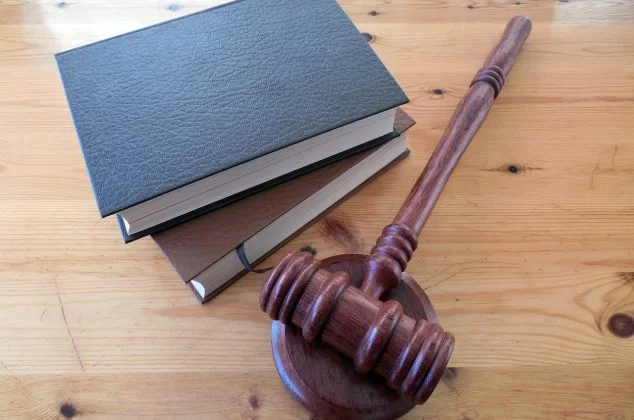 Gavel and legal books resting on table