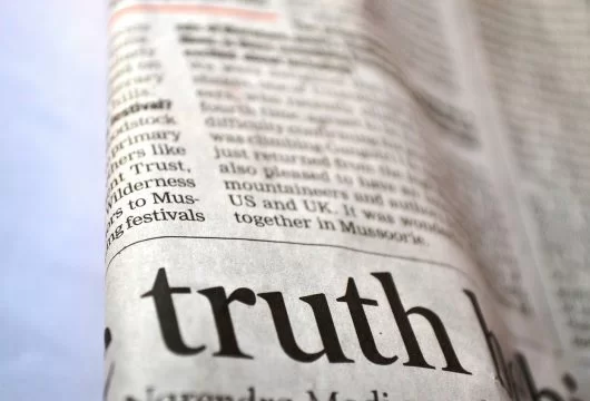 Close-up of a newspaper showing current events