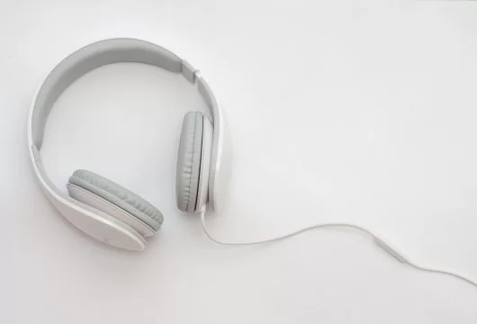 White and gray over-the-ear headphones on a white table