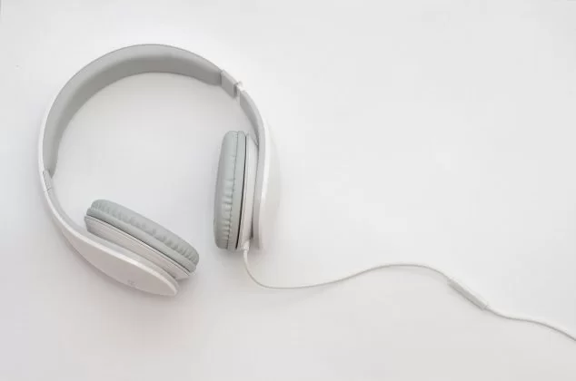 White and gray over-the-ear headphones on a white table