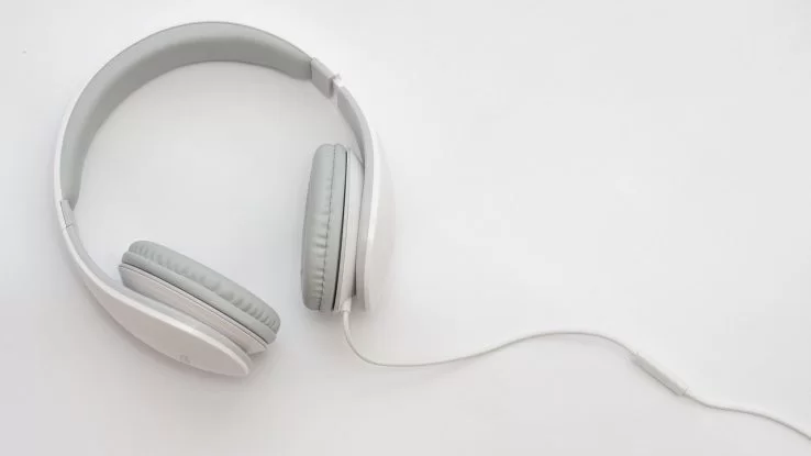 White and gray over-the-ear headphones on a white table