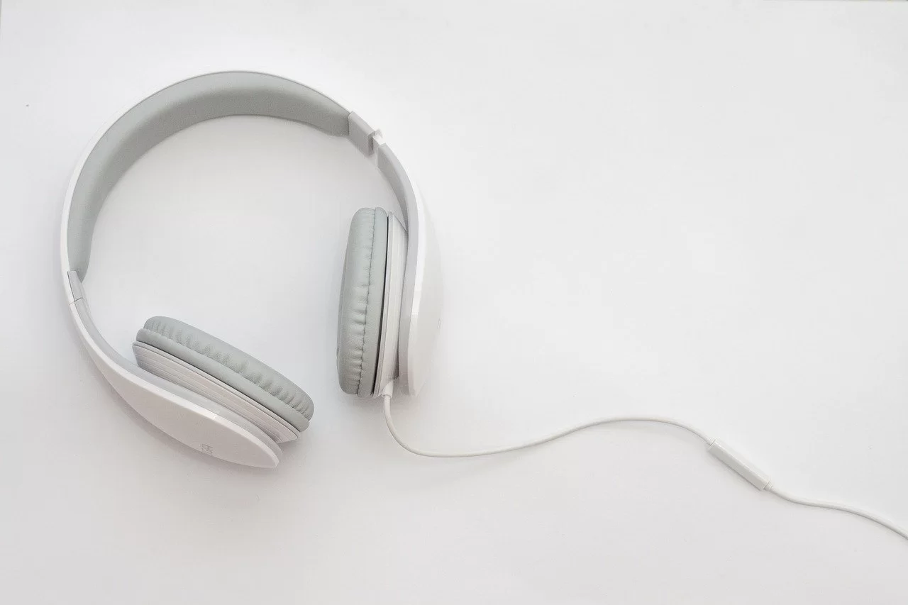 White and gray over-the-ear headphones on a white table