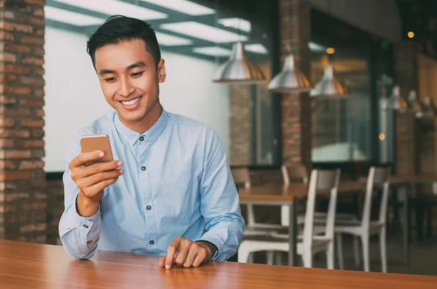 Man reading a group chat on his smartphone