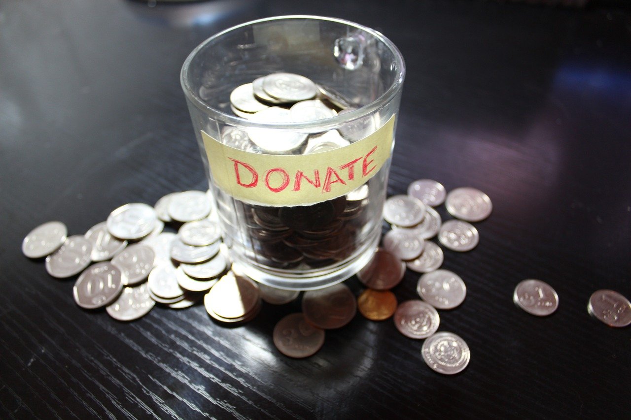Donation cup filled with coins