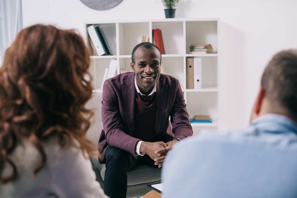 Three people attend a mental health team meeting