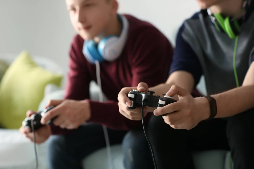 Two teenage boys playing a video game