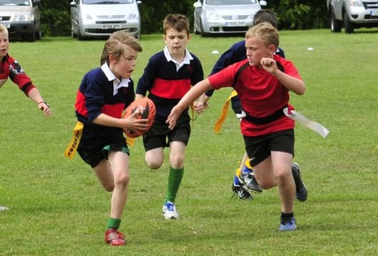Children playing tag rugby