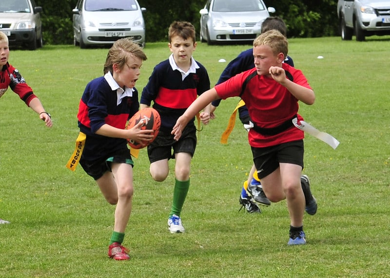 Children playing tag rugby