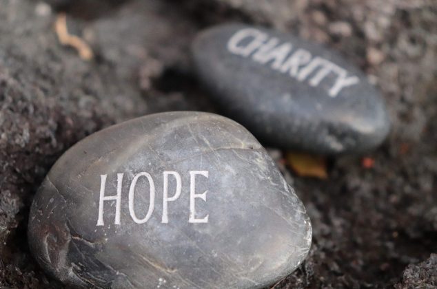 Rocks embossed with the words "hope" and "charity"