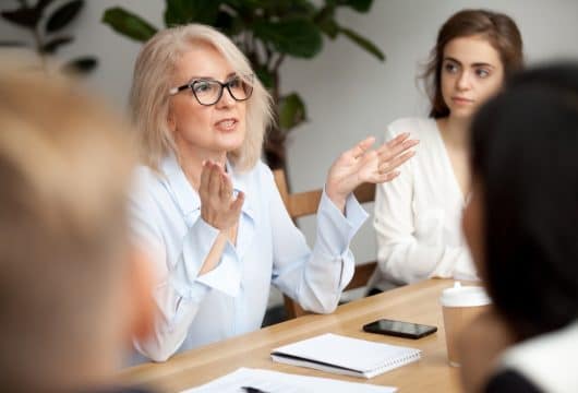 Middle-aged woman leading a mentor group