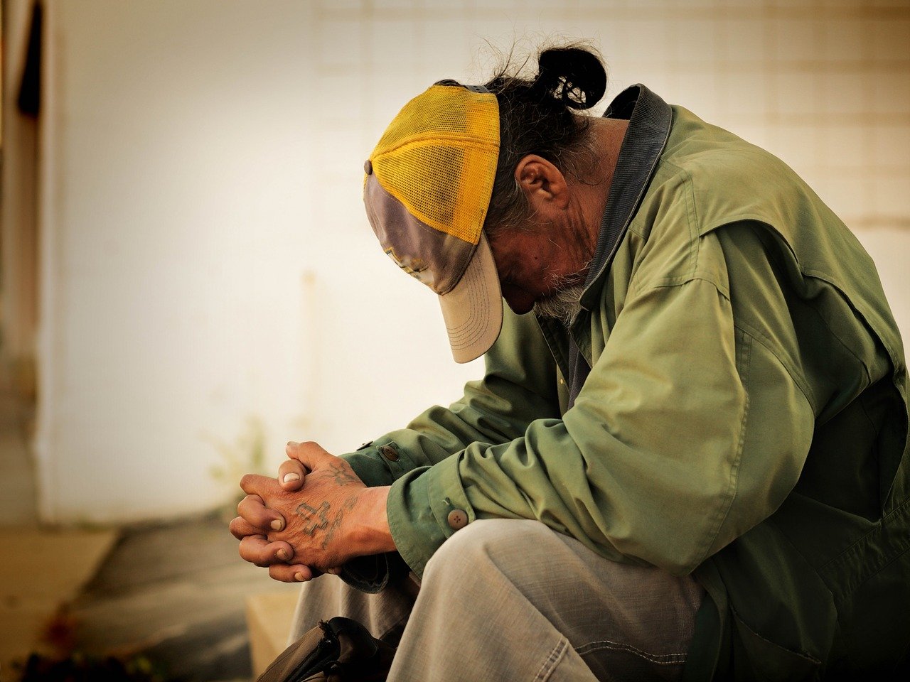 Man sitting outside of an outreach ministry building