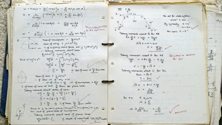 Open notebook with written math practice inside