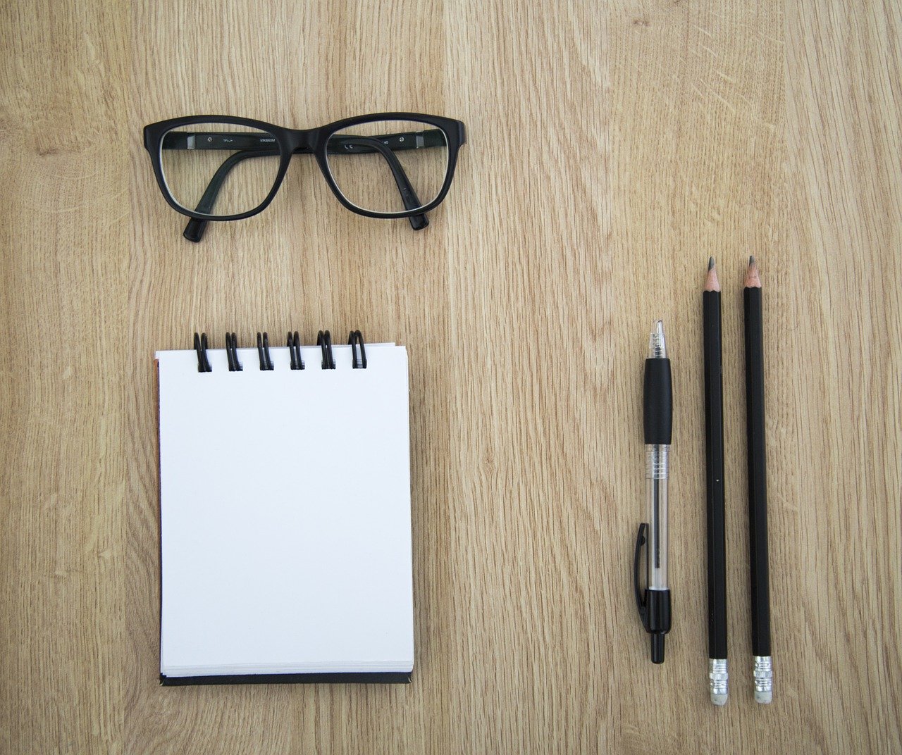Nerdy glasses with writing utensils and notebook