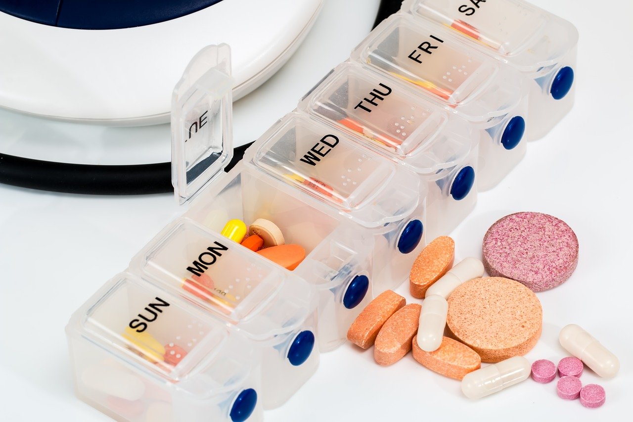 Prescription medications sorted in a day-labeled container
