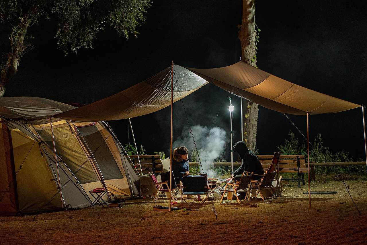 Campsite with a dark green tent at night