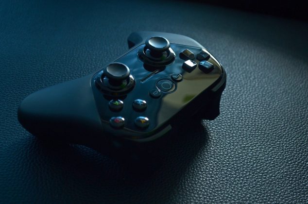 Video game controller resting on a black table