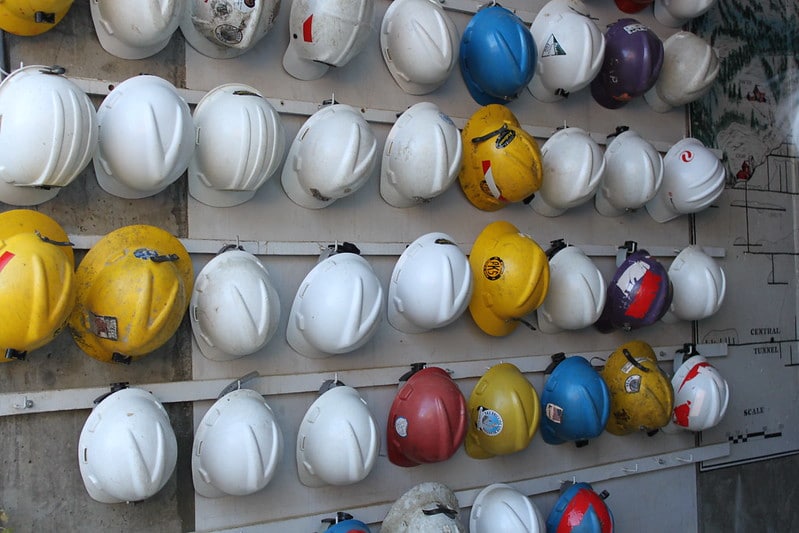 Hard hats hanging on a wall