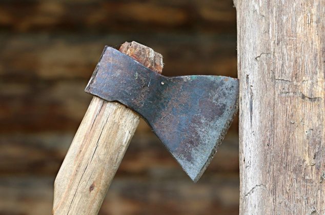Thrown axe stuck in a piece of wood