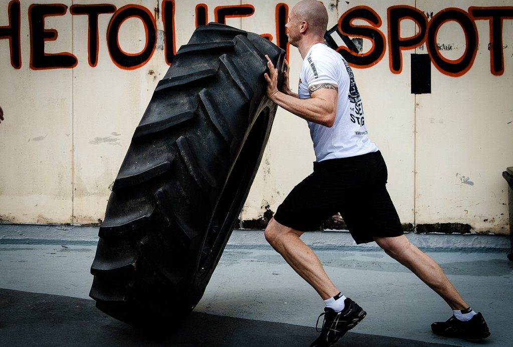 Man flipping a tire during a CrossFit workout