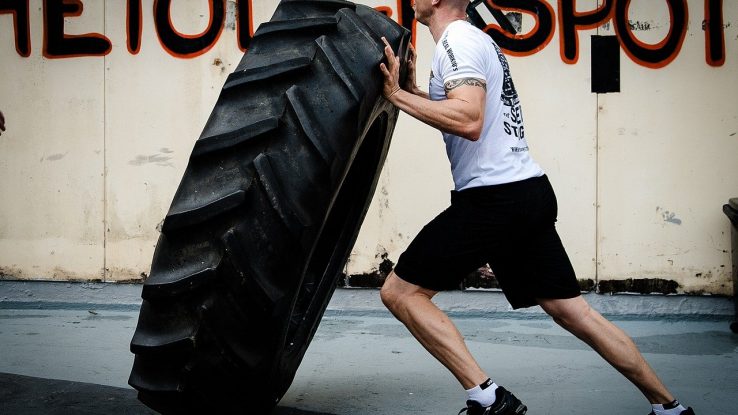 Man flipping a tire during a CrossFit workout