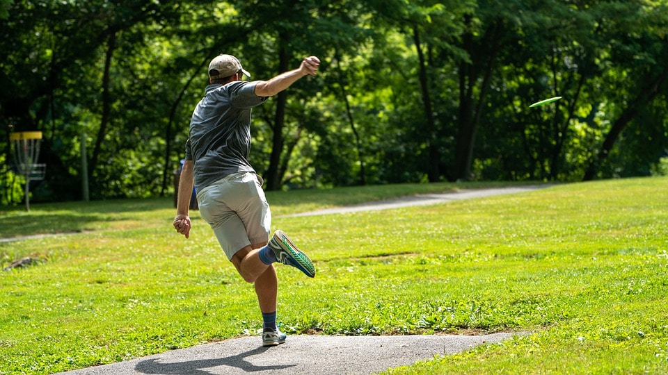 Disc golf player in a field