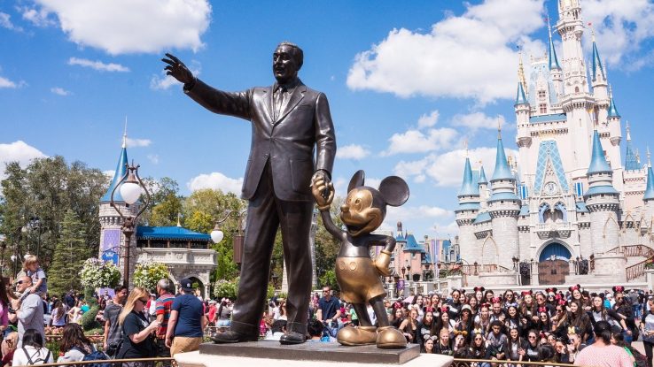 Walt Disney and Mickey Mouse statues at a Disney theme park