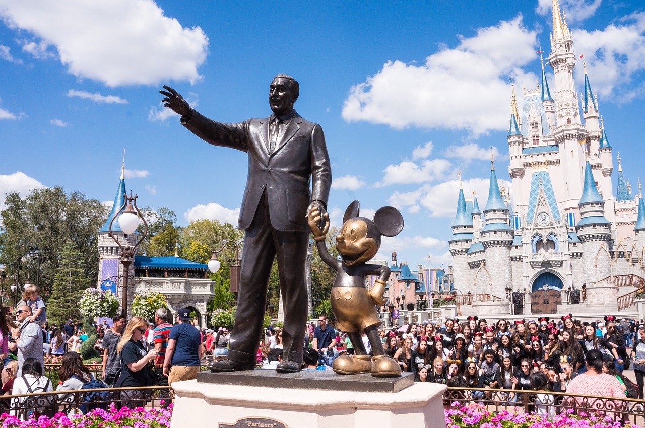 Walt Disney and Mickey Mouse statues at a Disney theme park