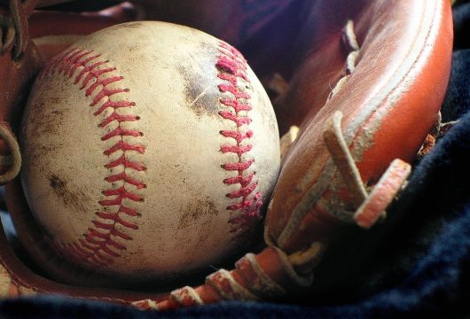 Close-up of a baseball resting in a glove