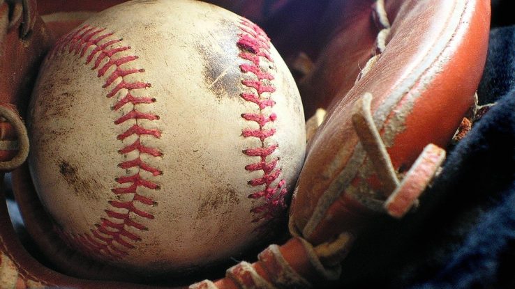 Close-up of a baseball resting in a glove