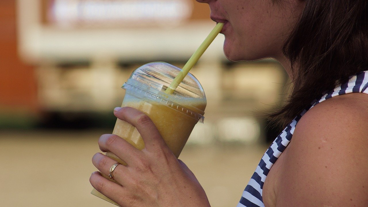 Woman drinking a shake from an Herbalife nutrition club