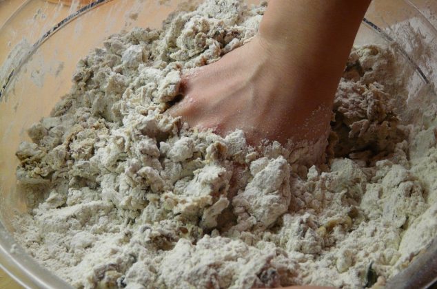 Bake off contestant mixing dough by hand