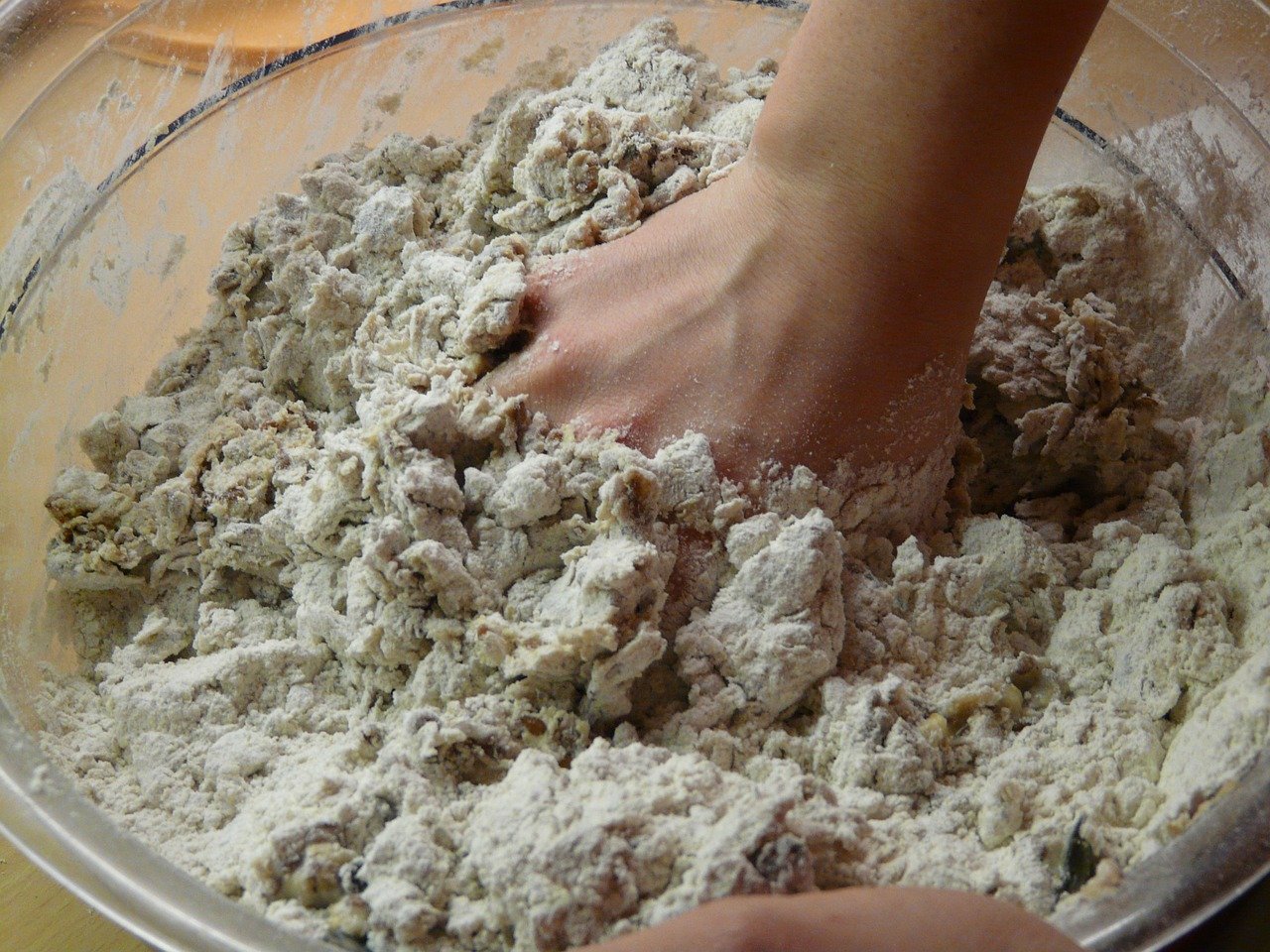 Bake off contestant mixing dough by hand