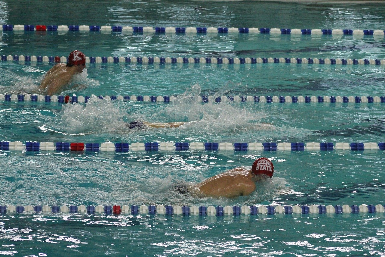 Swim team members in a pool during a competition