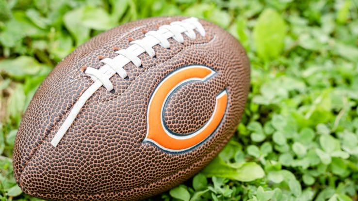 Football with Chicago Bears logo resting in the grass