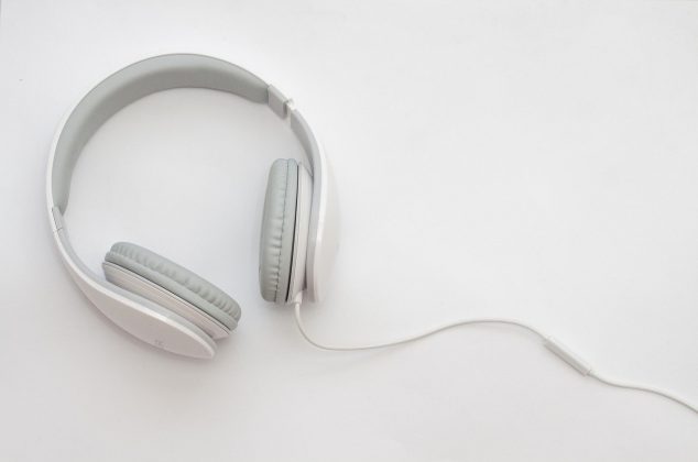 White and gray over-the-ear headphones on a white table