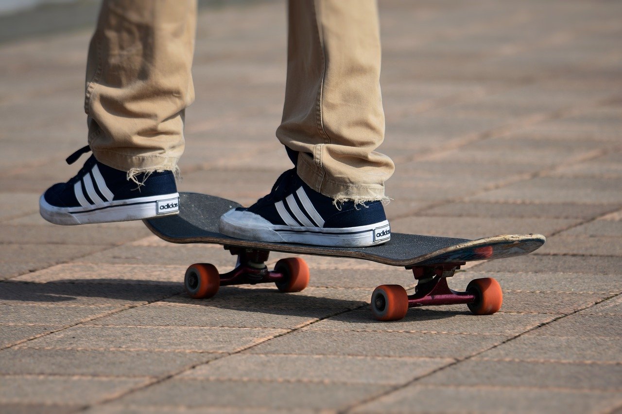 Person with tan pants and black shoes skateboarding