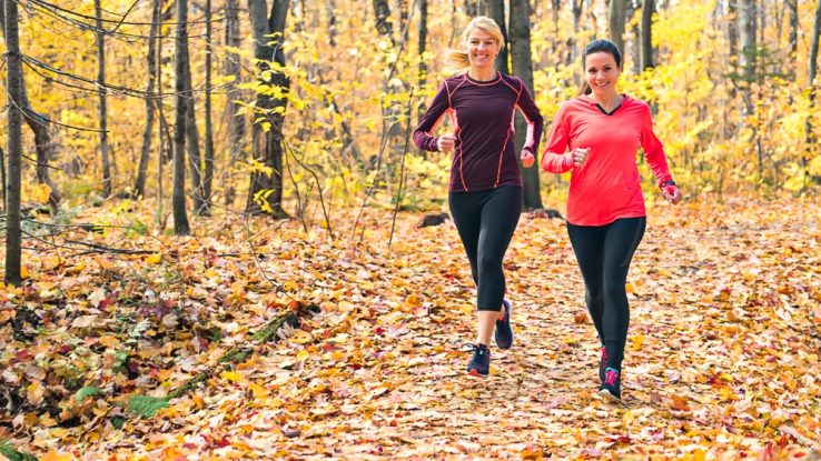 Two women running during a fall fitness challenge