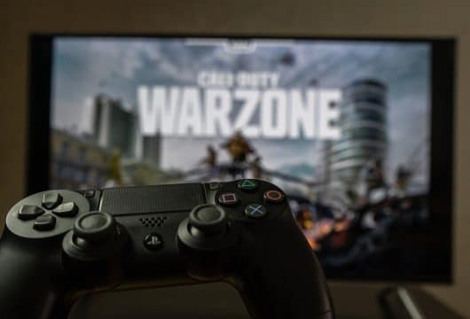 Gaming controller in front of a CoD Warzone screen