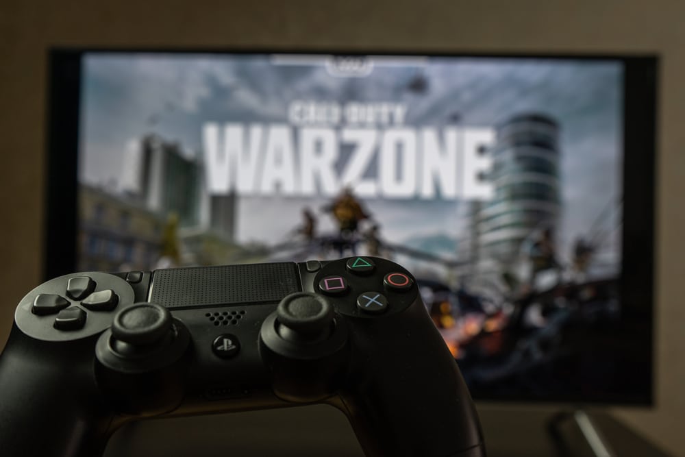 Gaming controller in front of a CoD Warzone screen