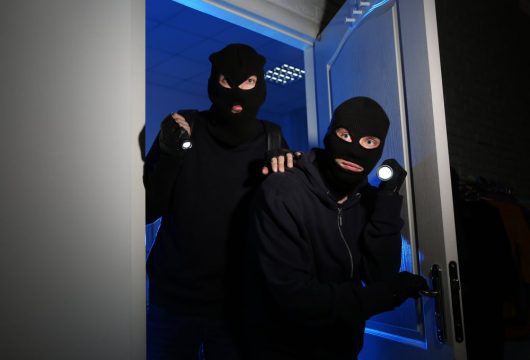 Thieves in ski masks with flashlights