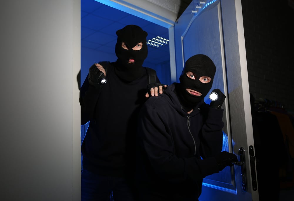 Thieves in ski masks with flashlights