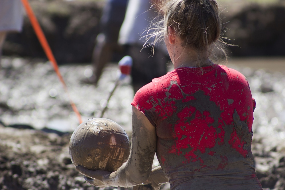 Woman playing mud volleyball