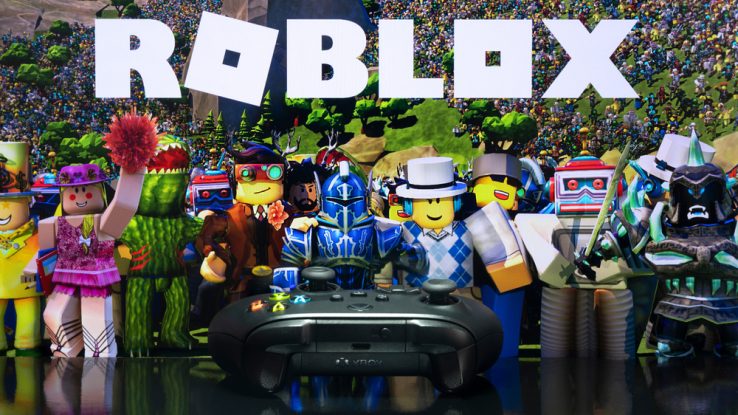 Roblox shown on a screen with a gaming controller in front of it