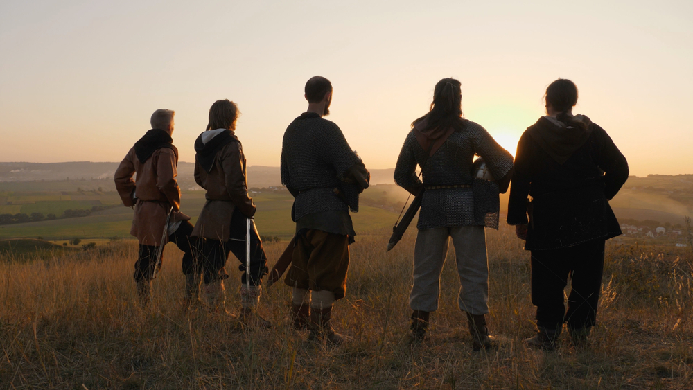 Group of warriors looking out at a battlefield