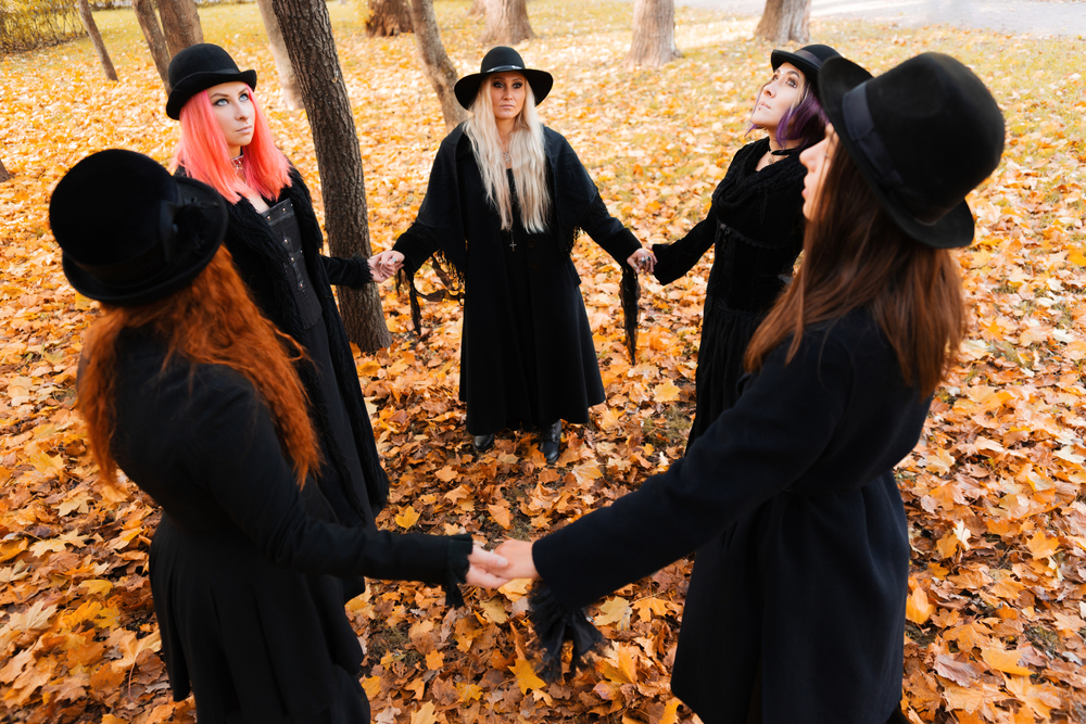 Witch coven meeting in a park during autumn