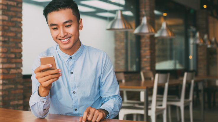 Man reading a group chat on his smartphone