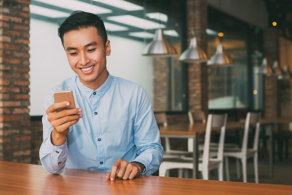 Man reading a group chat on his smartphone